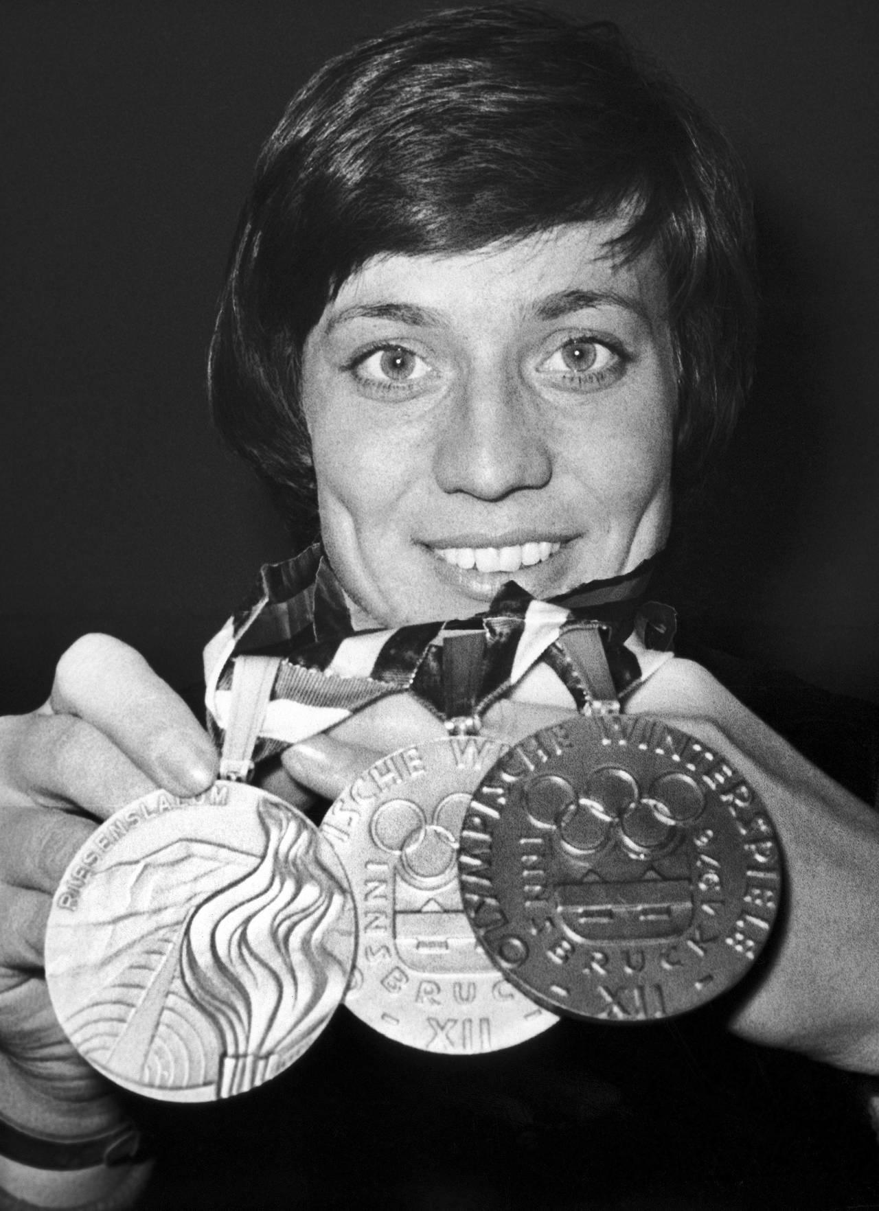 FILE - German alpine ski racer Rosi Mittermaier shows two gold medals and one silver, she won at th...