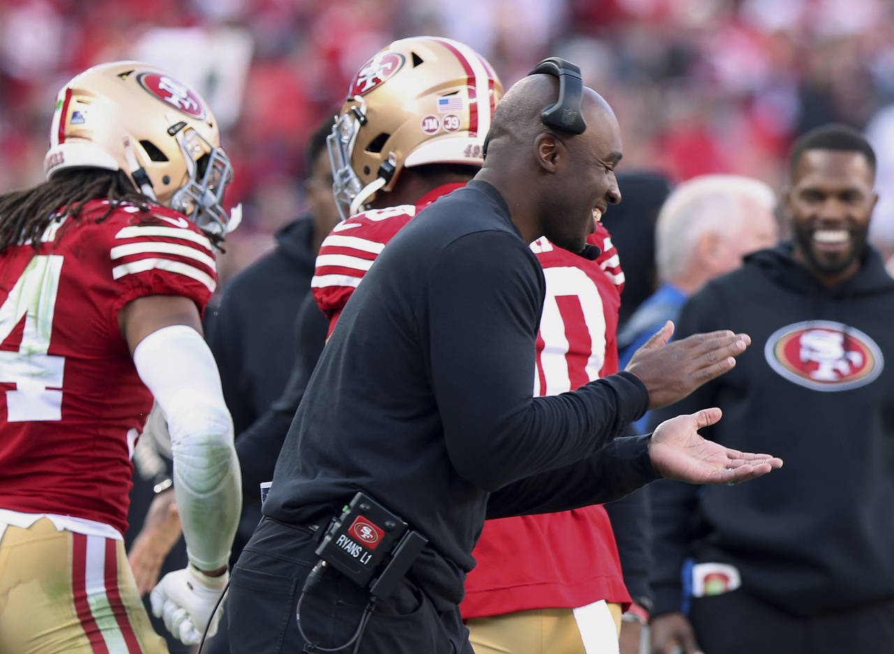 FILE - San Francisco 49ers defensive coordinator DeMeco Ryans celebrate on the sideline during the ...
