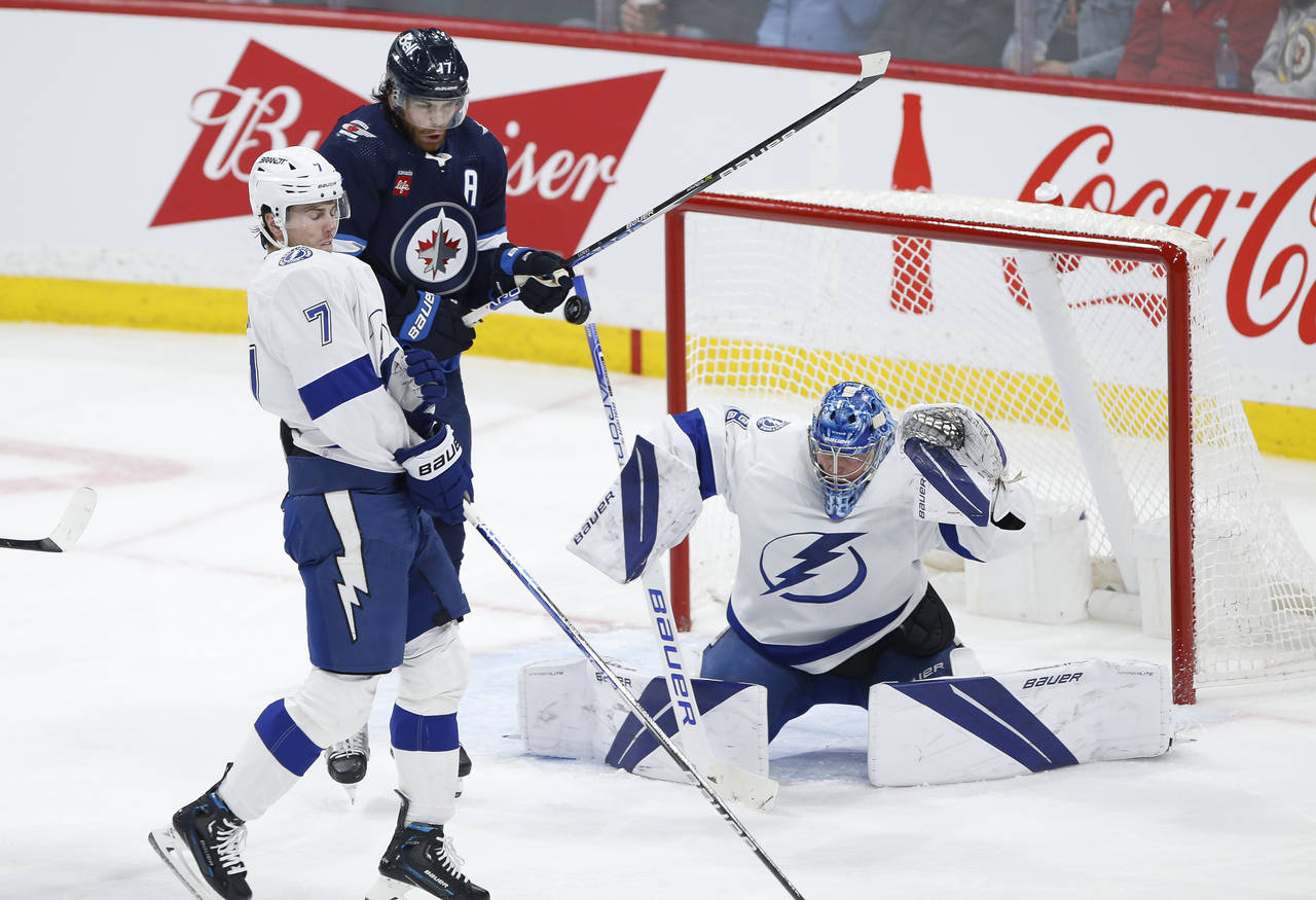 Winnipeg Jets' Adam Lowry (17) attempts to tip the puck past Tampa Bay Lightning goaltender Andrei ...