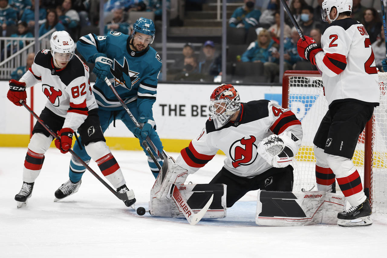 New Jersey Devils defenseman Nikita Okhotiuk (82) defends against San Jose Sharks center Tomas Hert...