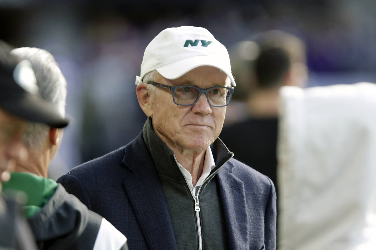 FILE - New York Jets owner Woody Johnson stands on the field before an NFL football game against th...
