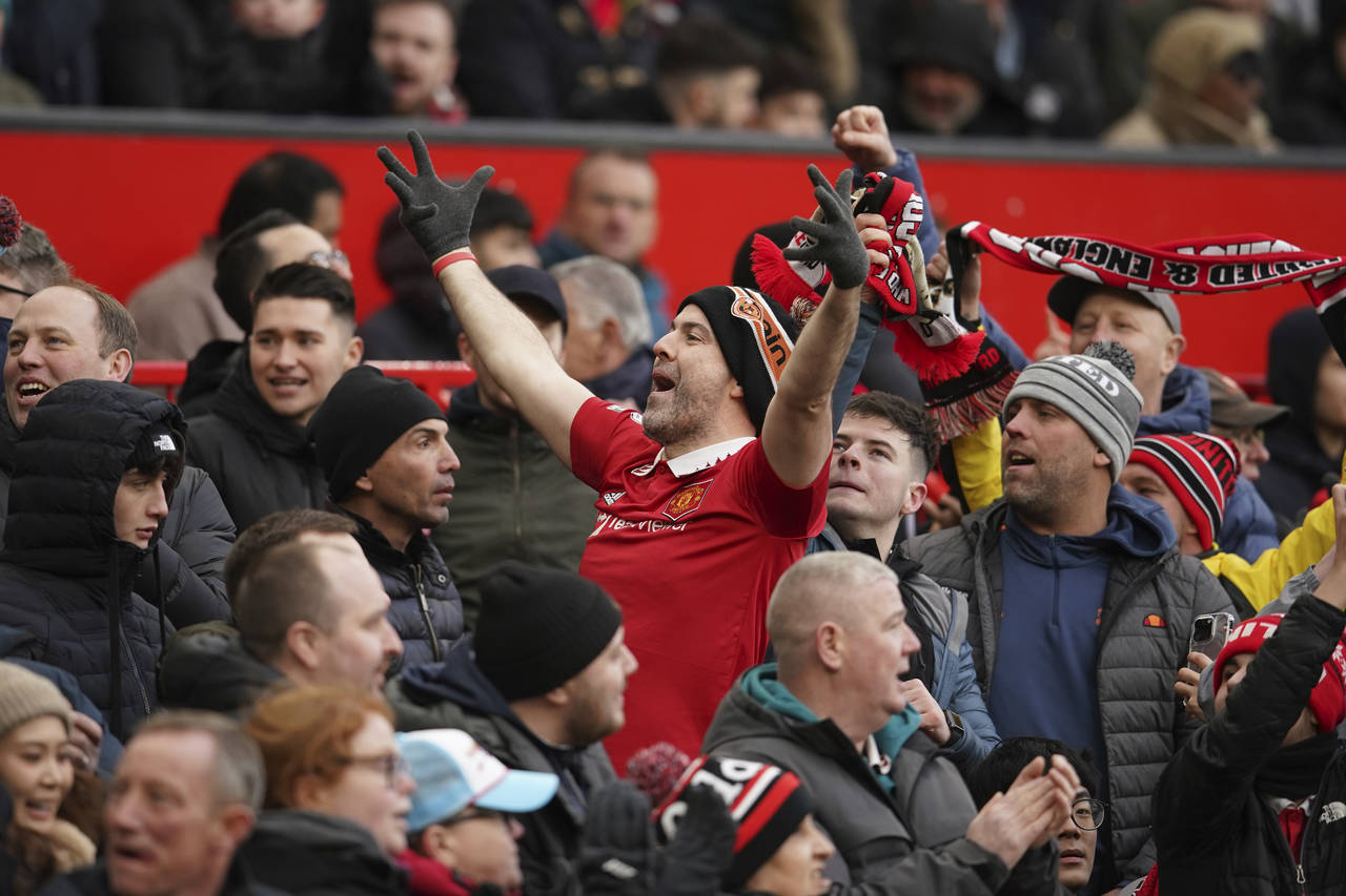 A fan cheers after Manchester United took the lead during the English Premier League soccer match b...