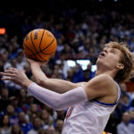 Adams scores late, No. 2 Kansas edges No. 14 Iowa St 62-60