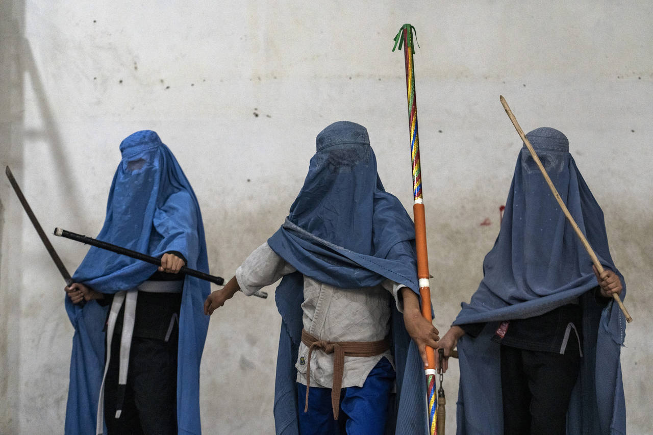 Afghan girls who practice wushu, a Chinese martial art, pose for a photo in Kabul, Afghanistan, Sun...