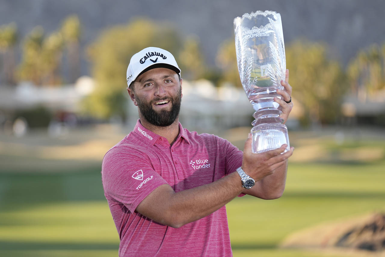 Jon Rahm hold the winner's trophy after the American Express golf tournament on the Pete Dye Stadiu...