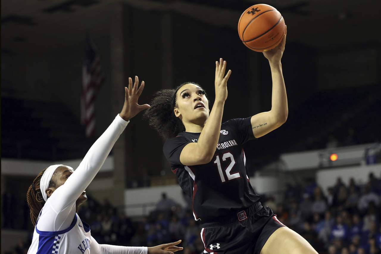 South Carolina's Mar'shaun Bostic (12) shoots near Kentucky's Cassidy Rowe, left, during the second...