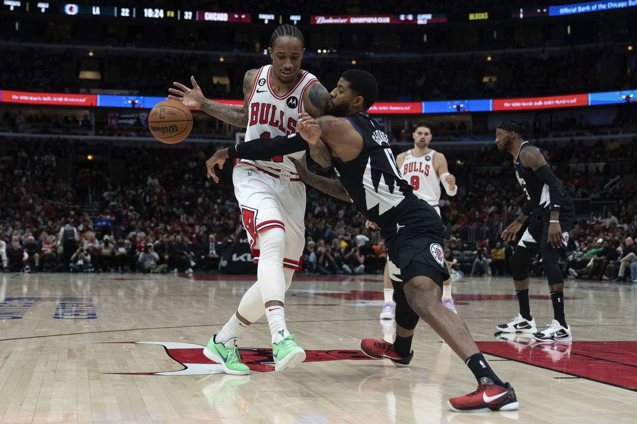 Los Angeles Clippers guard Paul George, right, slaps the ball away from Chicago Bulls forward DeMar...
