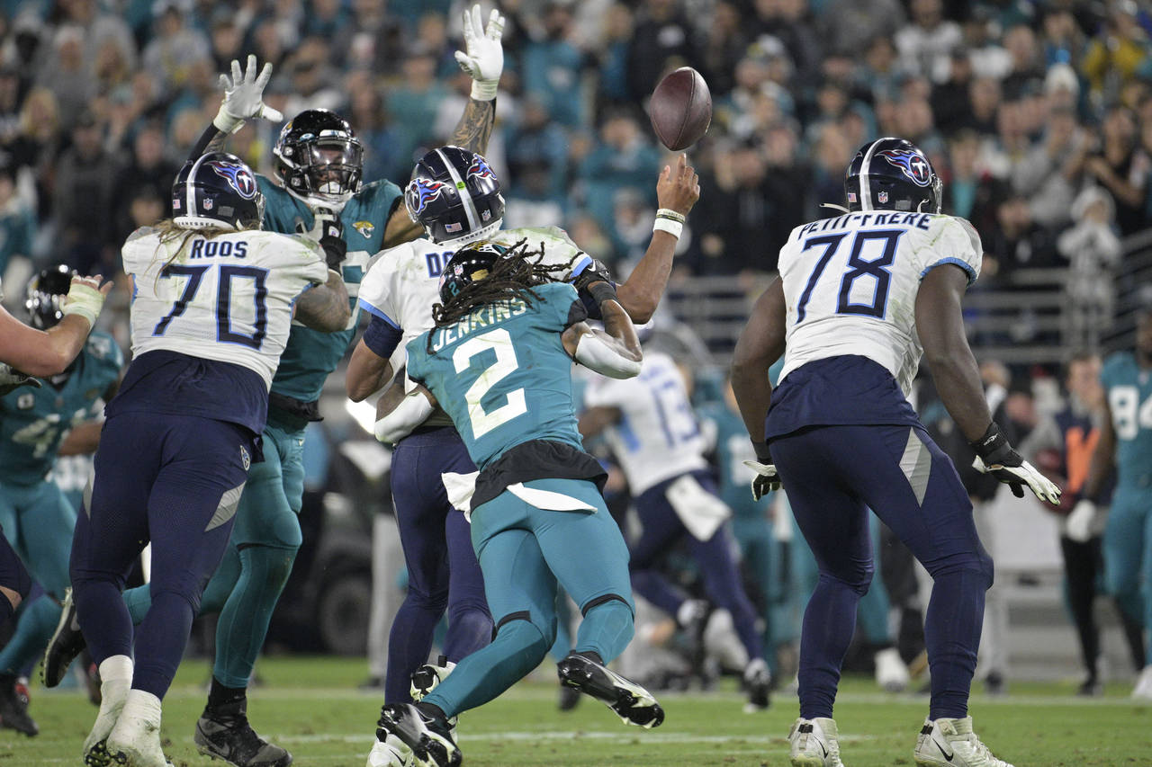Tennessee Titans quarterback Joshua Dobbs fumbles as he is hit by Jacksonville Jaguars safety Raysh...