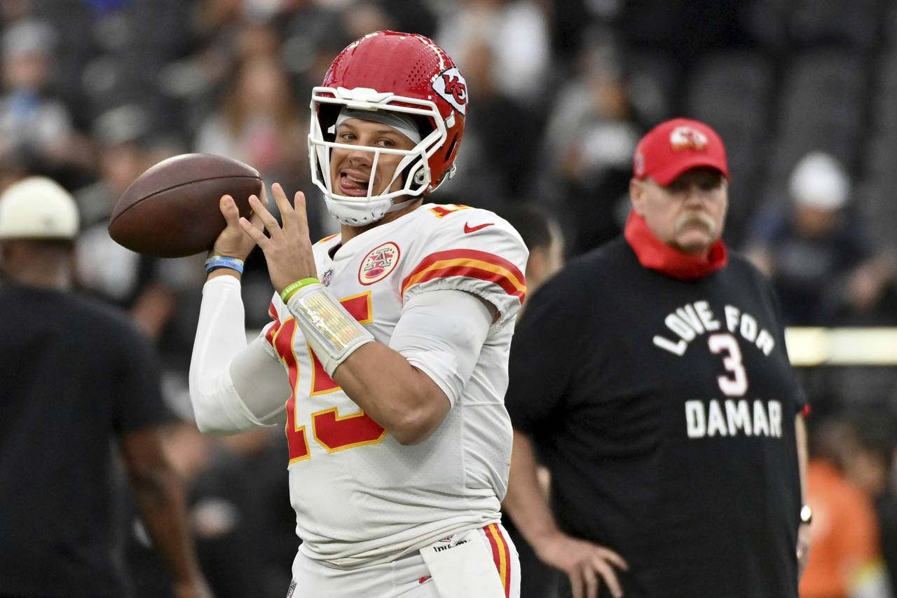 Kansas City Chiefs head coach Andy Reid, right, wears a shirt paying tribute to Buffalo Bills safet...