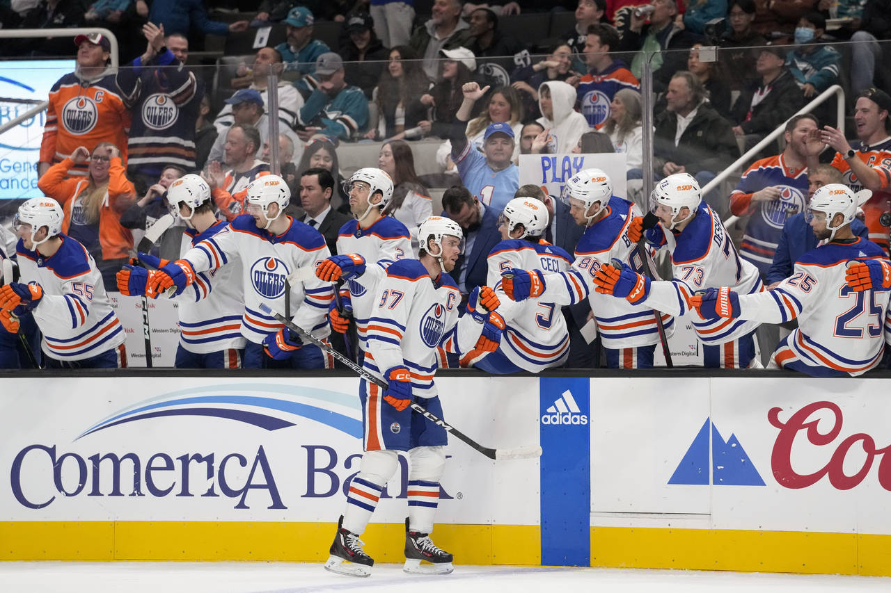 Edmonton Oilers center Connor McDavid (97) is congratulated after scoring against the San Jose Shar...