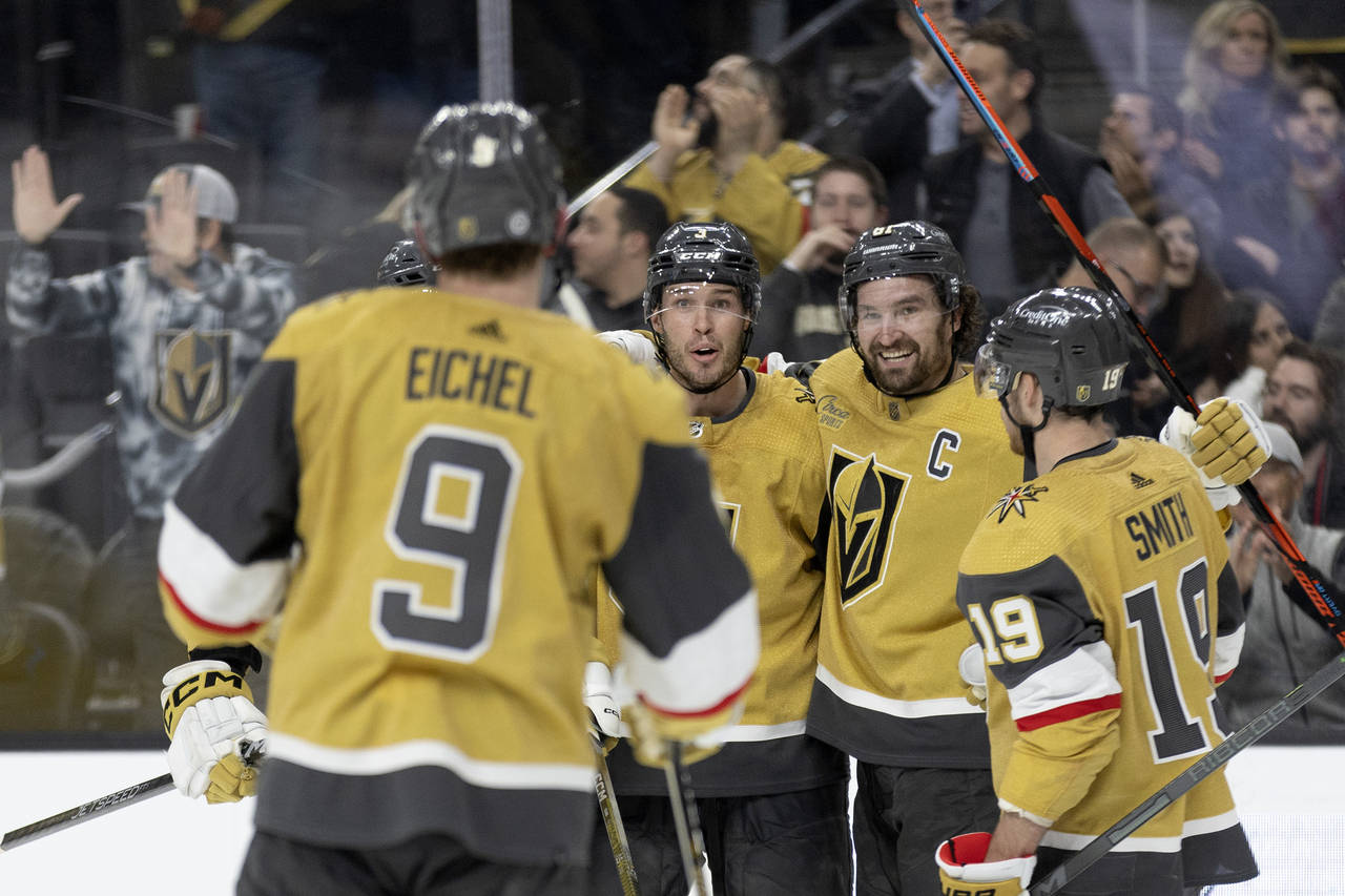 Vegas Golden Knights right wing Mark Stone, second from right, celebrates his goal with center Jack...
