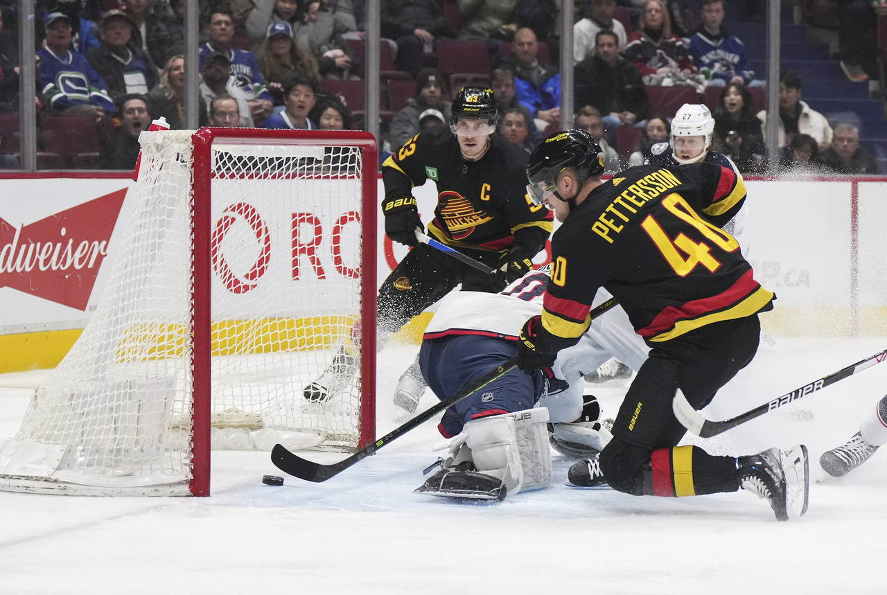 Vancouver Canucks' Elias Pettersson (40) scores against Columbus Blue Jackets goalie Joonas Korpisa...