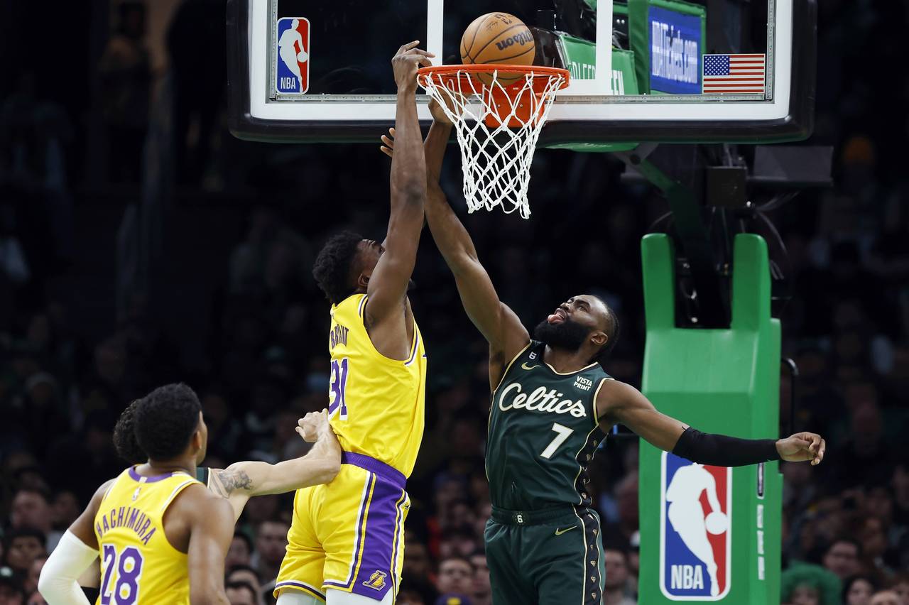 Boston Celtics' Jaylen Brown (7) fouls Los Angeles Lakers' Thomas Bryant (31) during the first half...
