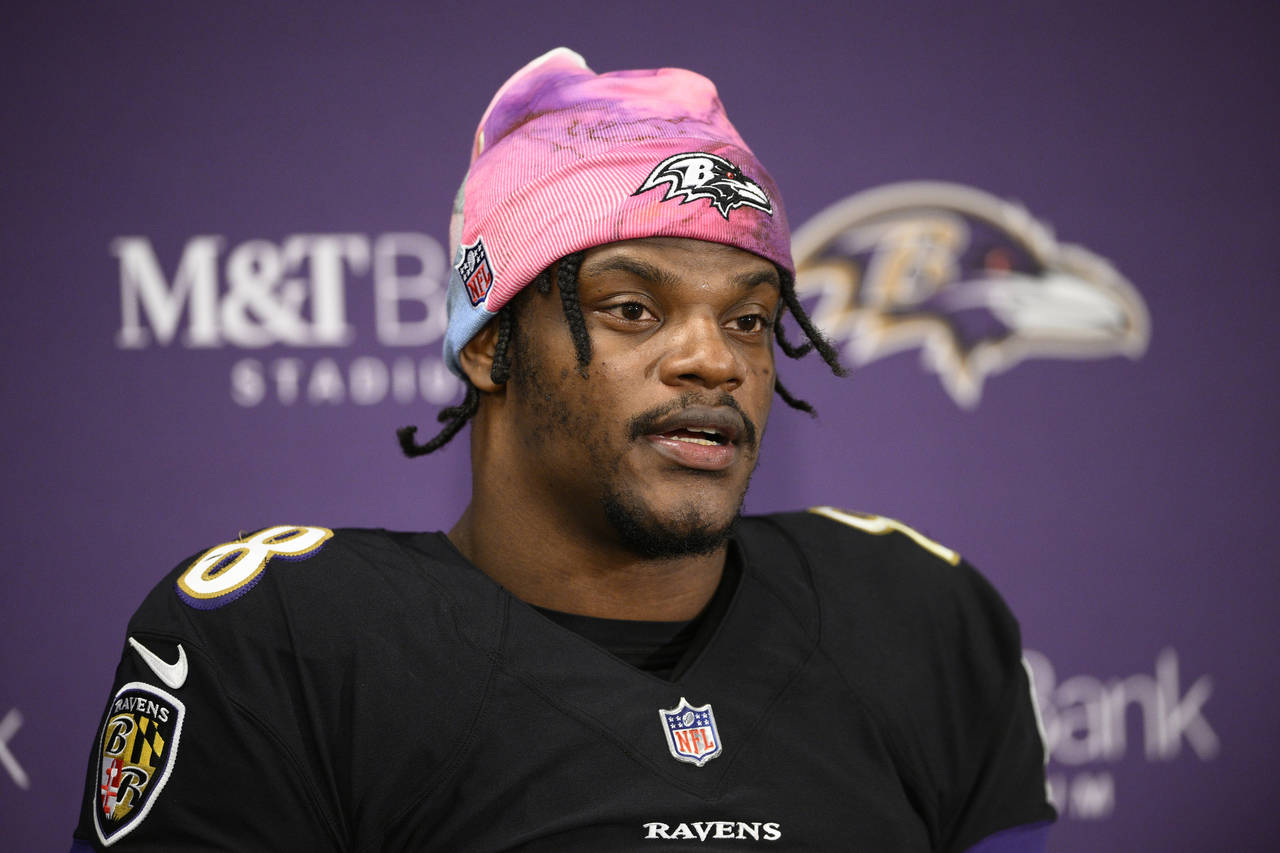 FILE - Baltimore Ravens quarterback Lamar Jackson (8) speaks to the media at a press conference aft...