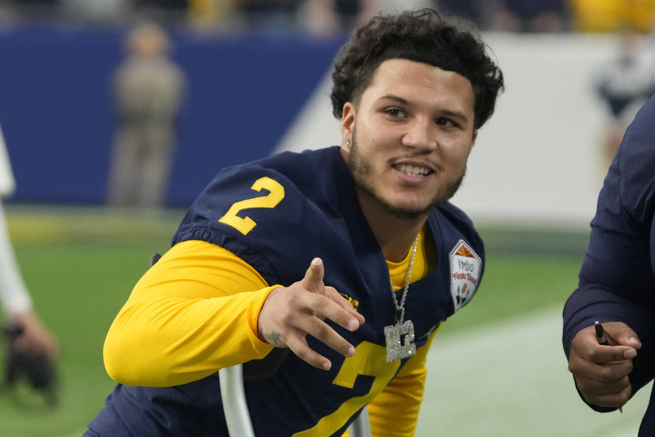FILE - Michigan running back Blake Corum (2) gestures during the first half of the Fiesta Bowl NCAA...
