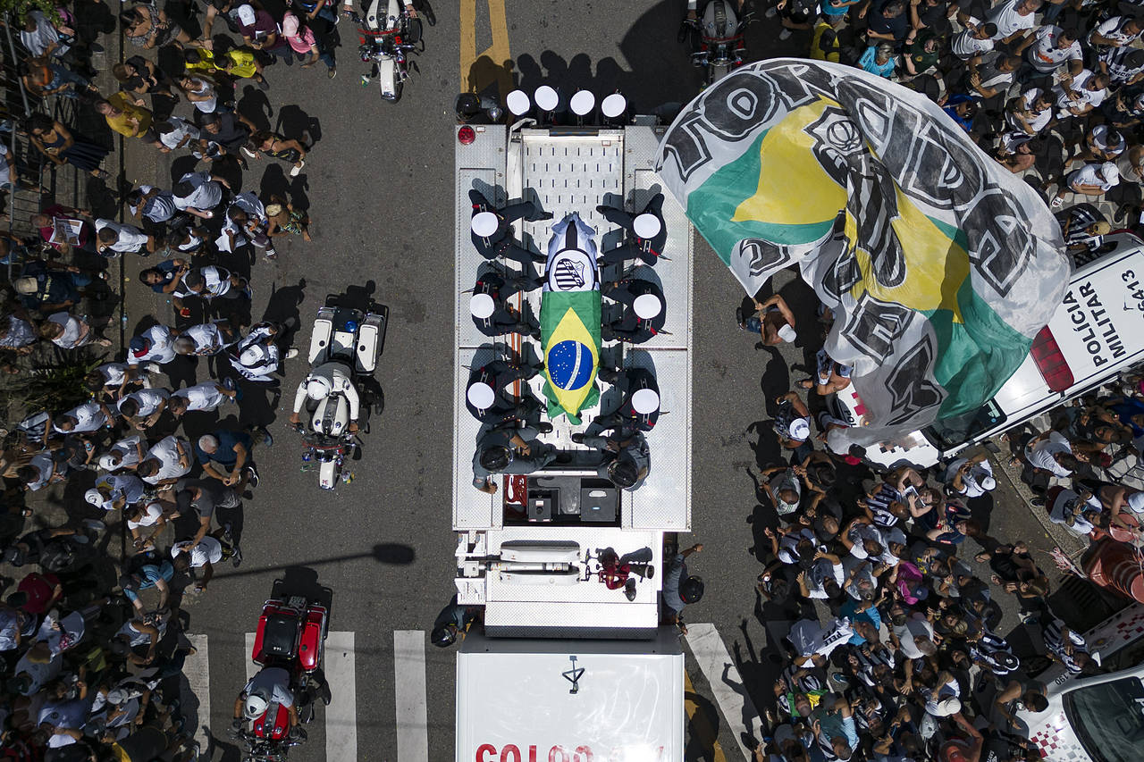 The casket of late Brazilian soccer great Pele is draped in the Brazilian and Santos FC soccer club...