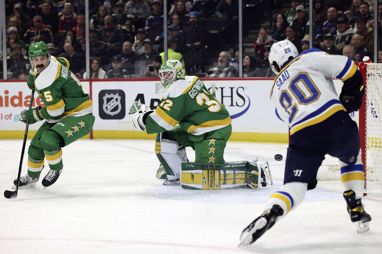 Minnesota Wild goaltender Filip Gustavsson (32) watches St. Louis Blues left wing Brandon Saad (20)...