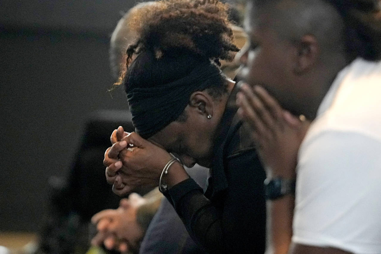 A woman prays during a prayer service for Buffalo Bills' Damar Hamlin at Crossroads Uptown Church, ...