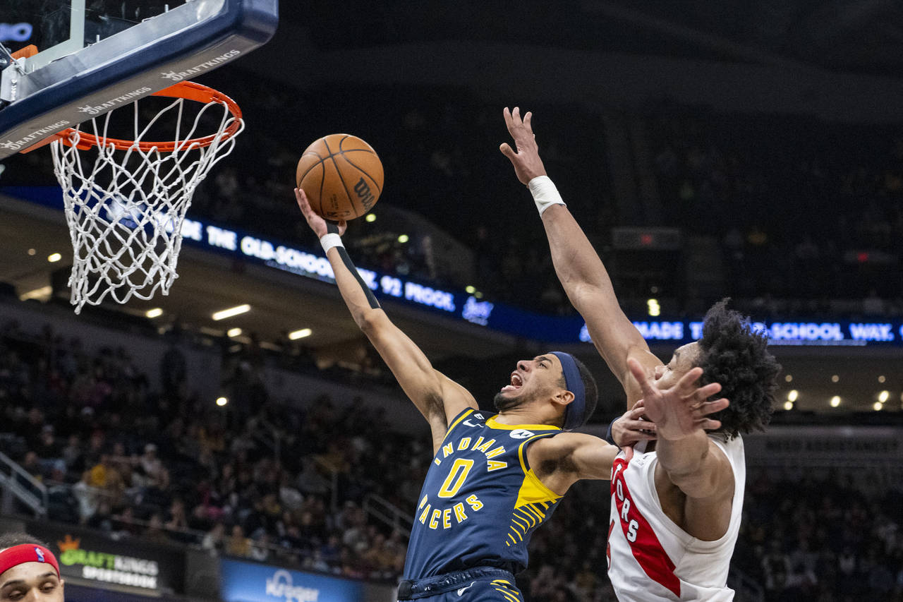 Indiana Pacers guard Tyrese Haliburton (0) shoots while being defended by Toronto Raptors forward S...