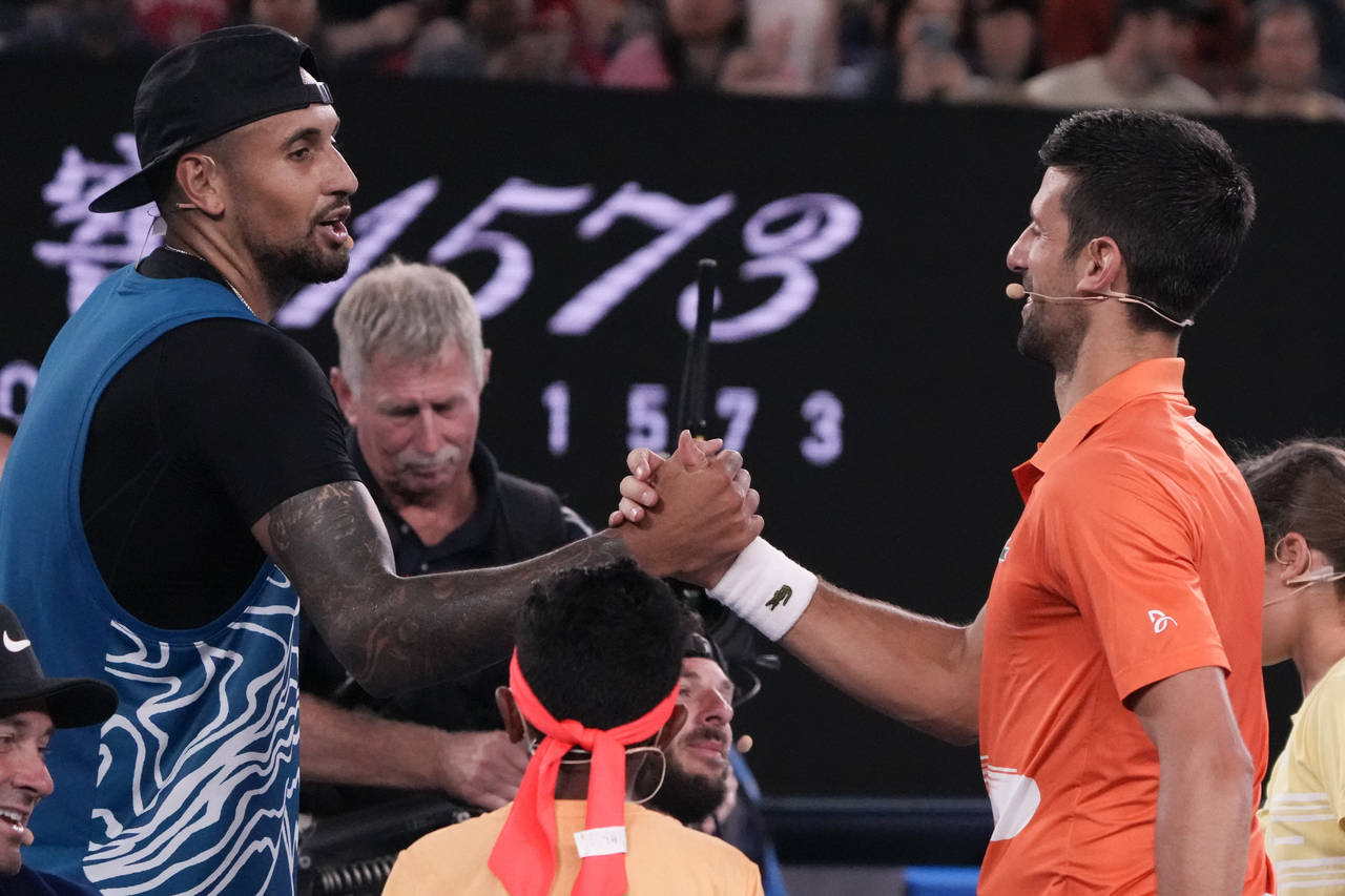 Australia's Nick Kyrgios, left, and Serbia's Novak Djokovic shake hands following an exhibition mat...