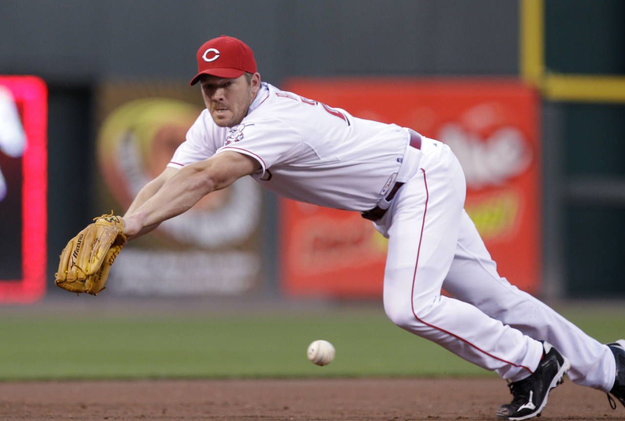 FILE - Cincinnati Reds third baseman Scott Rolen fields a ball hit by the Arizona Diamondbacks in a...