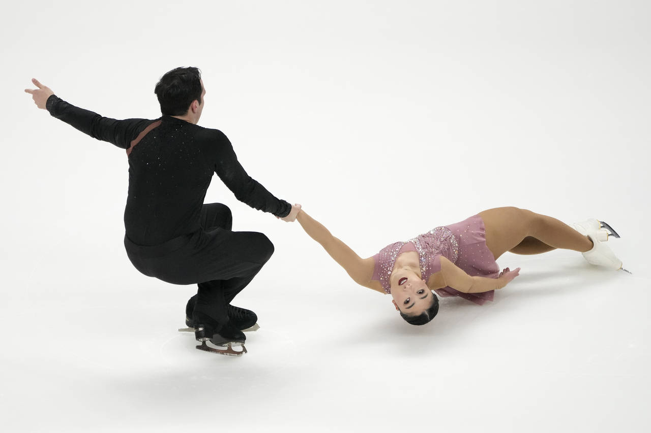 Rique Newby-Estrella, left, and Nina Ouellette perform during the pairs free skate at the U.S. figu...