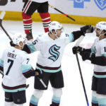 
              Seattle Kraken's Andre Burakovsky, center, celebrates his goal with Jordan Eberle (7) and Matty Beniers during the first period of the team's NHL hockey game against the Chicago Blackhawks on Saturday, Jan. 14, 2023, in Chicago. (AP Photo/Charles Rex Arbogast)
            