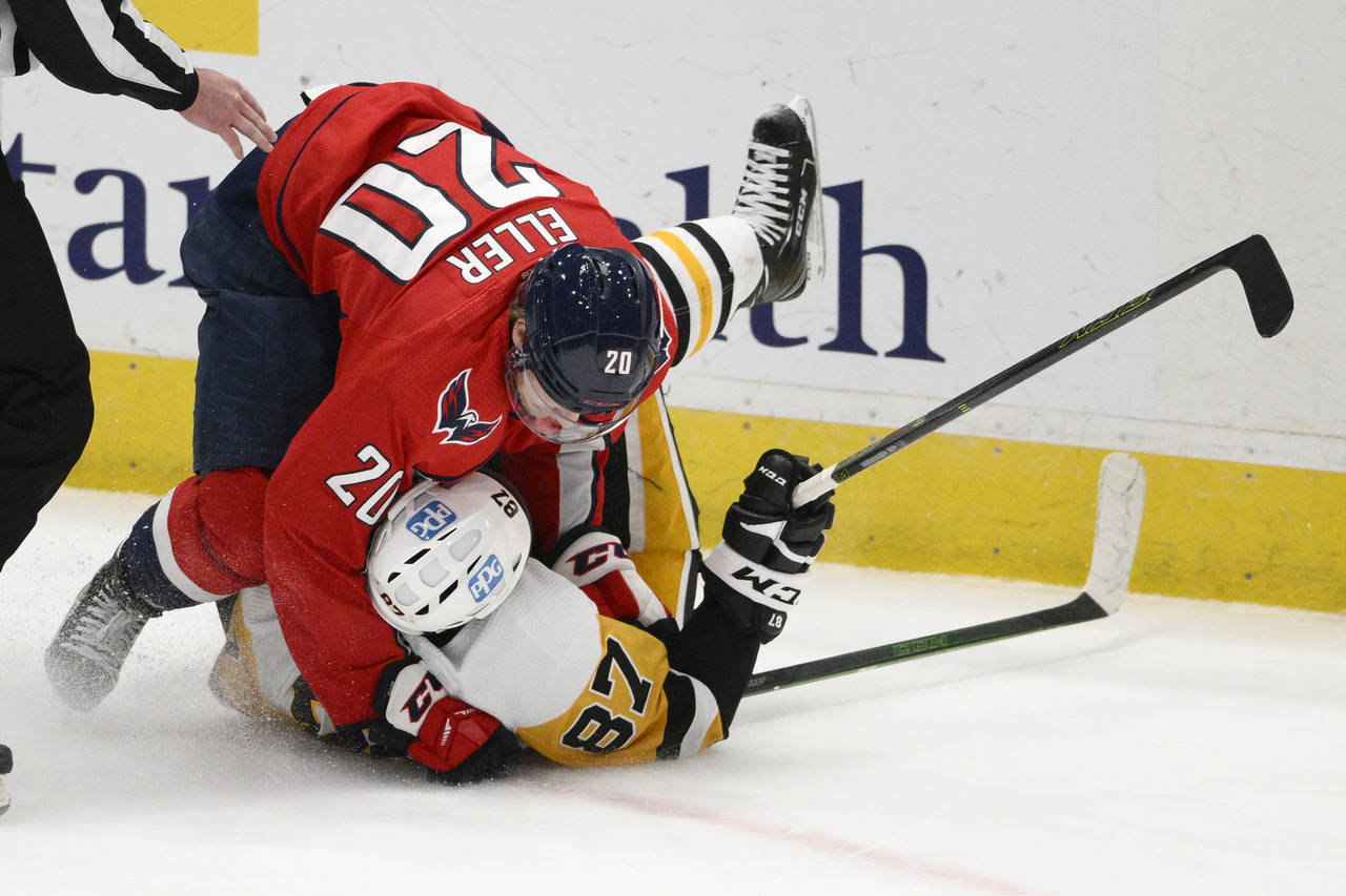 Washington Capitals center Lars Eller (20) takes down Pittsburgh Penguins center Sidney Crosby (87)...