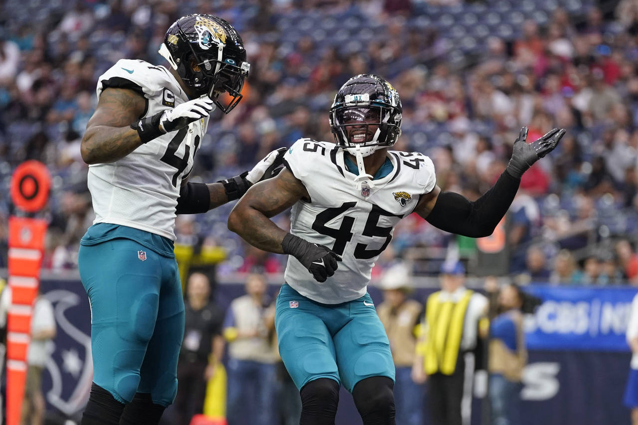 Jacksonville Jaguars linebacker K'Lavon Chaisson (45) celebrates with teammate Josh Allen (41) afte...