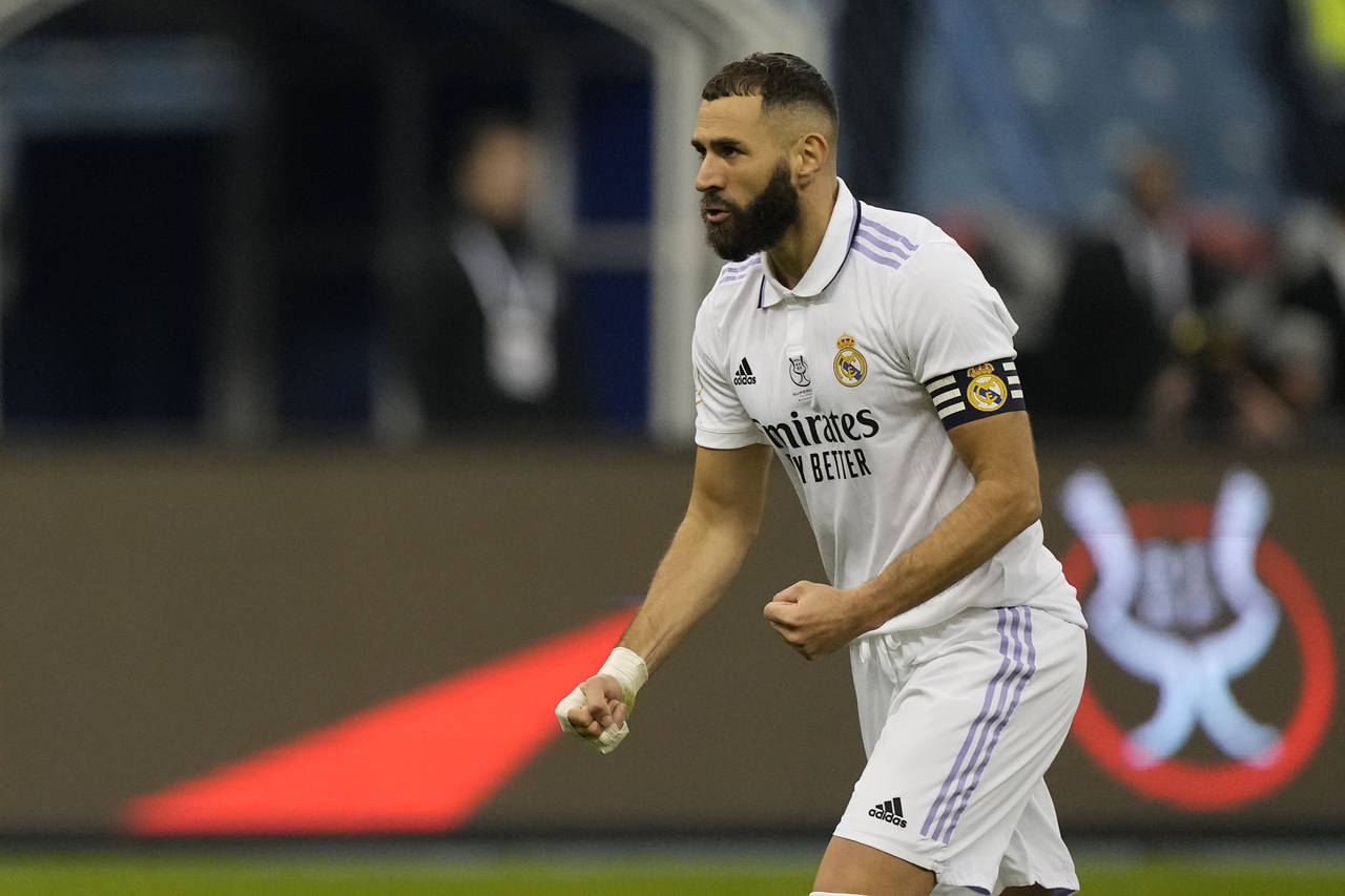 Real Madrid's Karim Benzema reacts after he scored during penalty shootout during a semi-final of t...