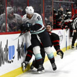 
              Seattle Kraken defenseman Adam Larsson (6) crashes into Ottawa Senators defenseman Thomas Chabot along the boards, leading to an interference penalty against the Kraken, during second-period NHL hockey game action in Ottawa, Ontario, Saturday, Jan. 7, 2023. (Justin Tang/The Canadian Press via AP)
            