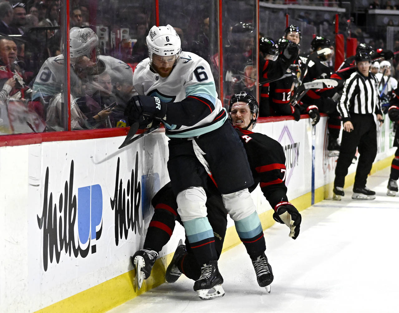 Seattle Kraken defenseman Adam Larsson (6) crashes into Ottawa Senators defenseman Thomas Chabot al...
