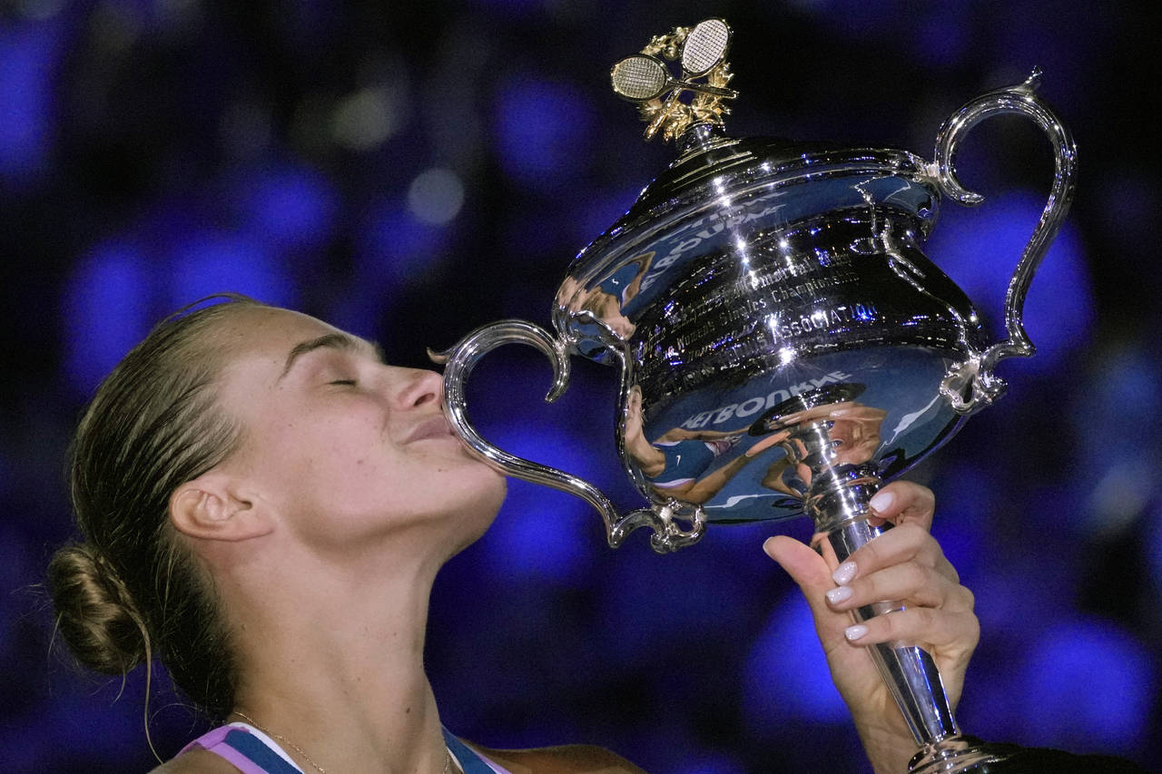 Aryna Sabalenka of Belarus kisses the Daphne Akhurst Memorial Trophy after defeating Elena Rybakina...