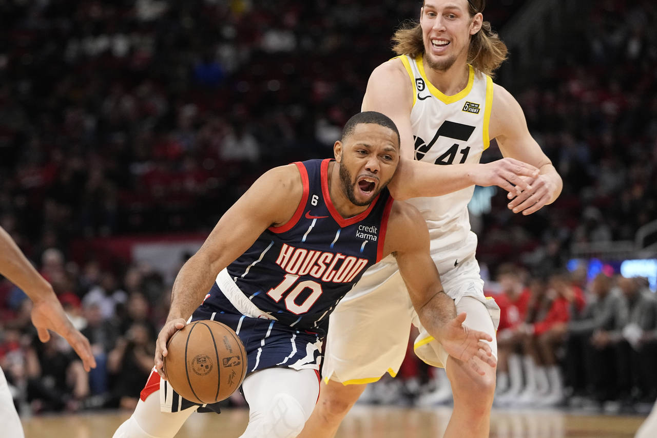 Houston Rockets' Eric Gordon (10) is fouled by Utah Jazz's Kelly Olynyk (41) during the first half ...