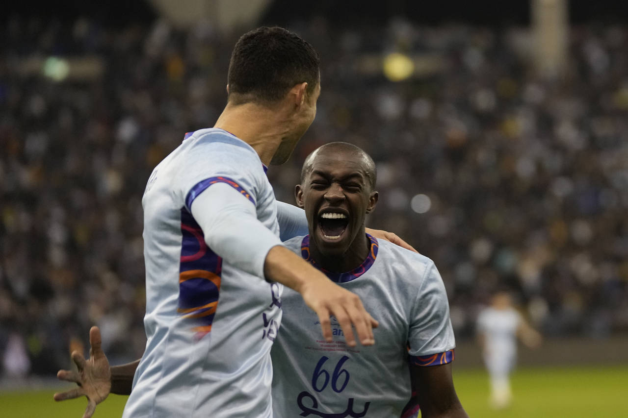 Cristiano Ronaldo celebrates with Saud Abdulhamid after scoring his side's second goal playing for ...