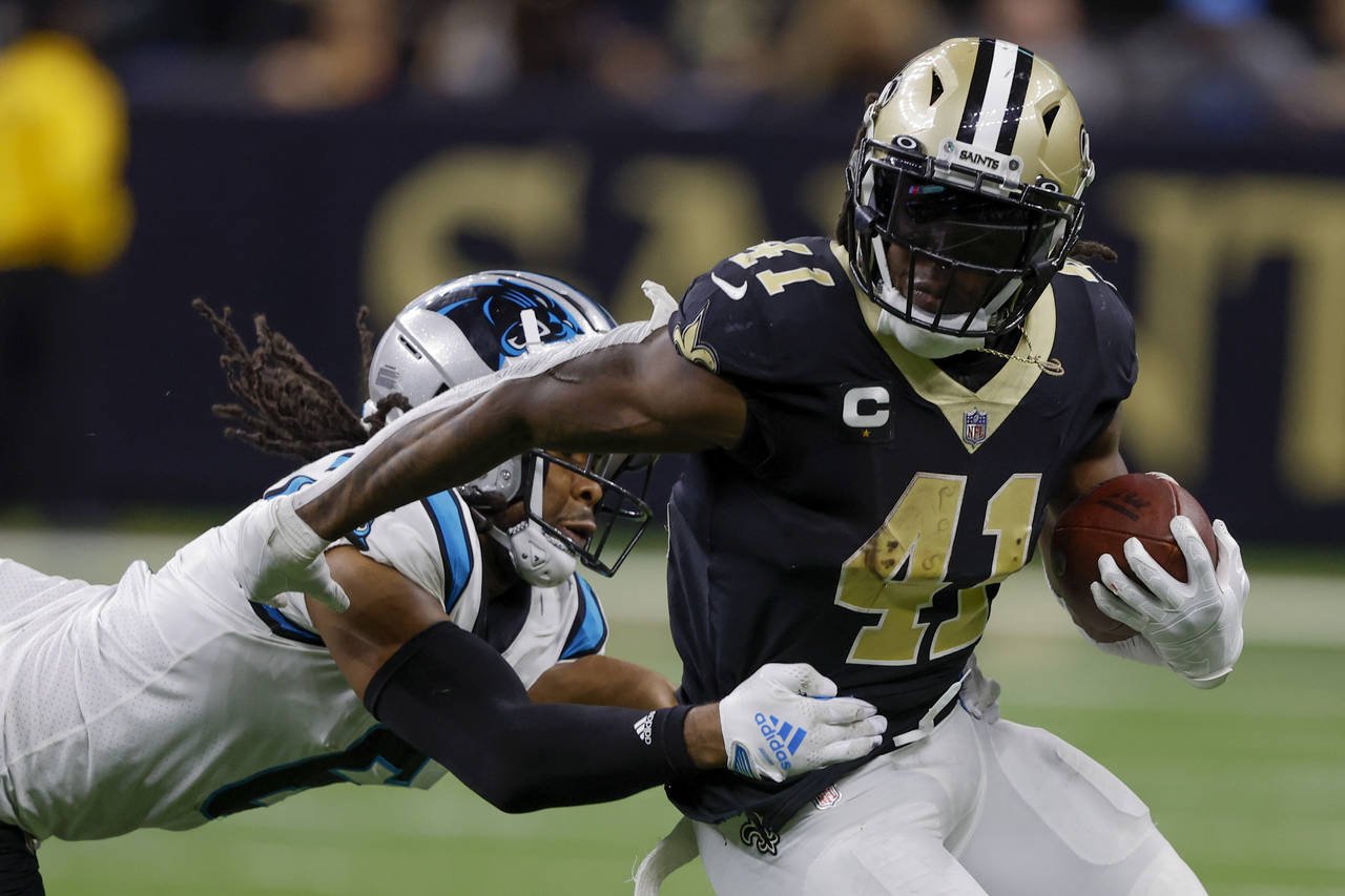 New Orleans Saints running back Alvin Kamara is tackled by Carolina Panthers cornerback Josh Norman...