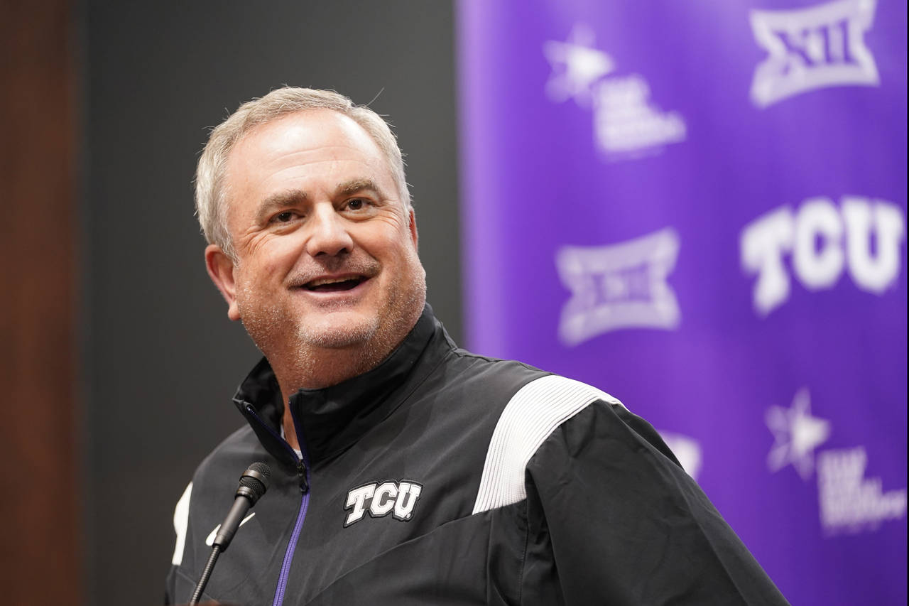 TCU head football coach Sonny Dykes smiles as he speaks to reporters in Fort Worth, Texas, Tuesday,...