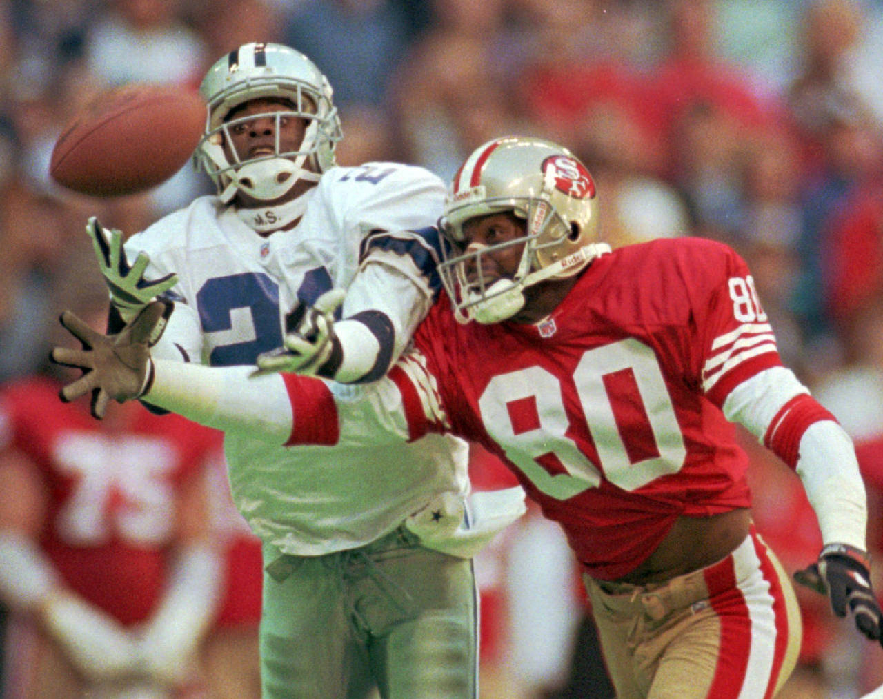 FILE - Dallas Cowboys defender Deion Sanders (21) knocks the ball away from San Francisco 49ers rec...