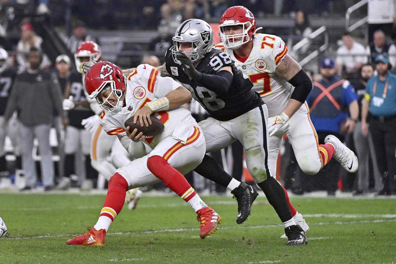 Kansas City Chiefs quarterback Patrick Mahomes (15) is sacked by Las Vegas Raiders defensive end Ma...