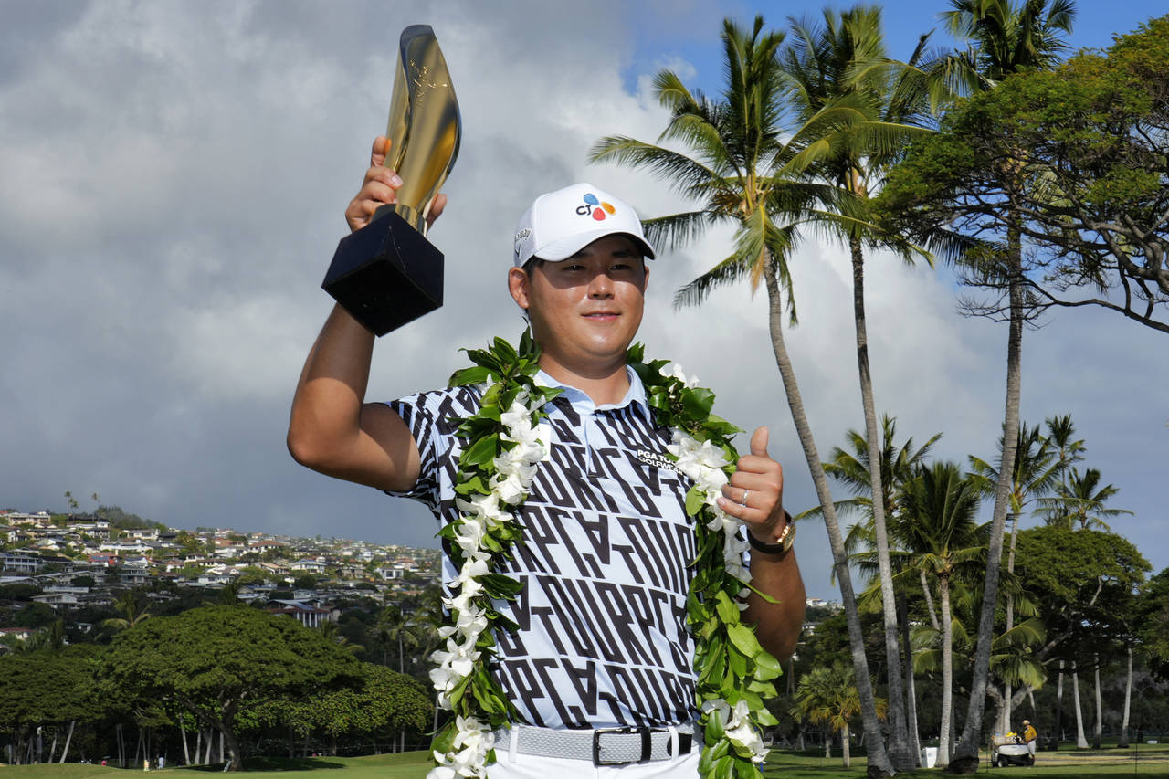 Si Woo Kim holds the champions trophy after the final round of the Sony Open golf tournament, Sunda...