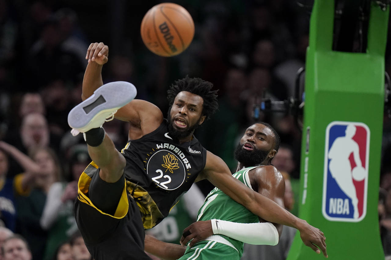 Golden State Warriors forward Andrew Wiggins (22) and Boston Celtics guard Jaylen Brown (7) vie for...