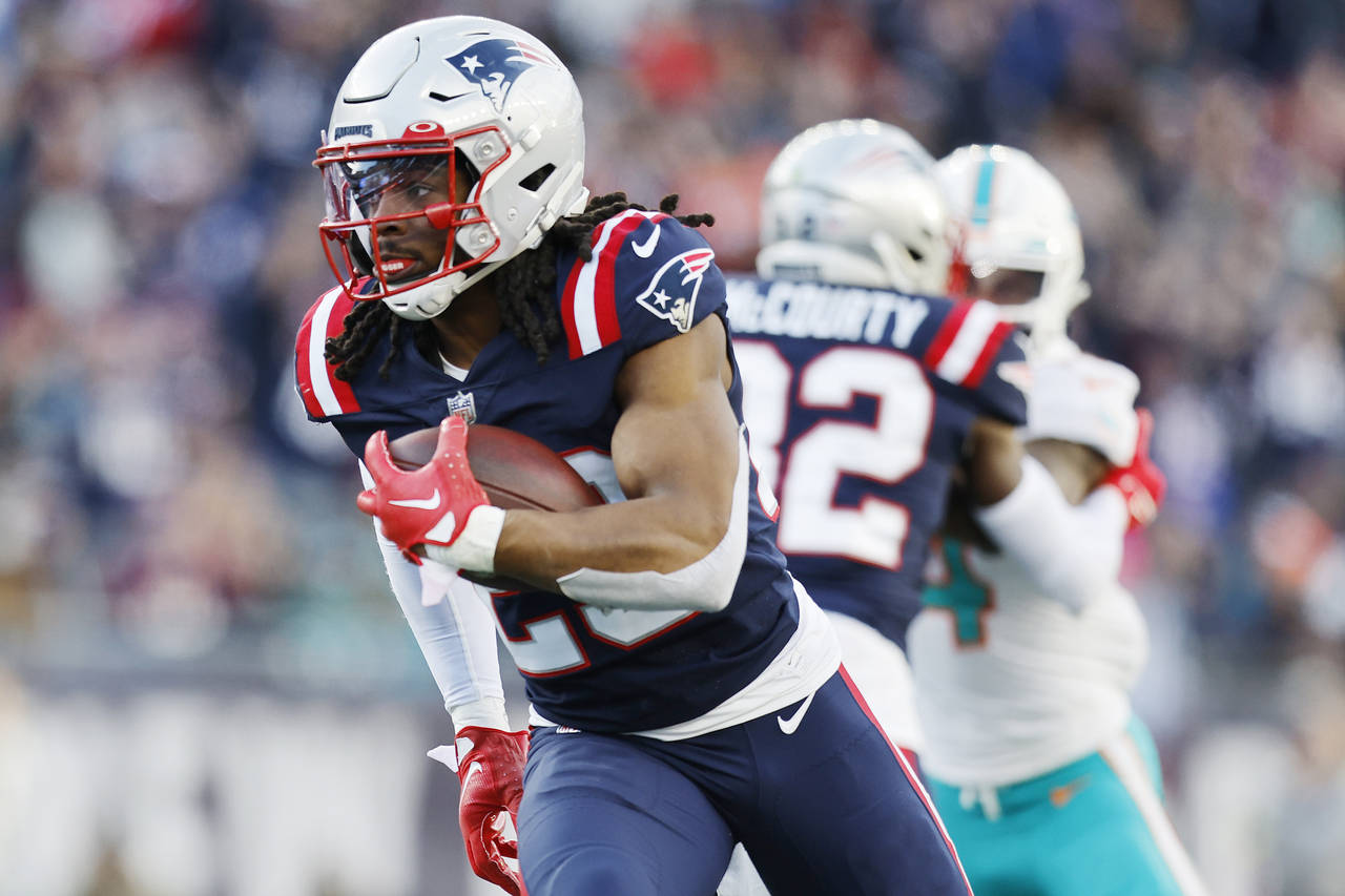 New England Patriots safety Kyle Dugger (23) heads towards the end zone, after intercepting the bal...