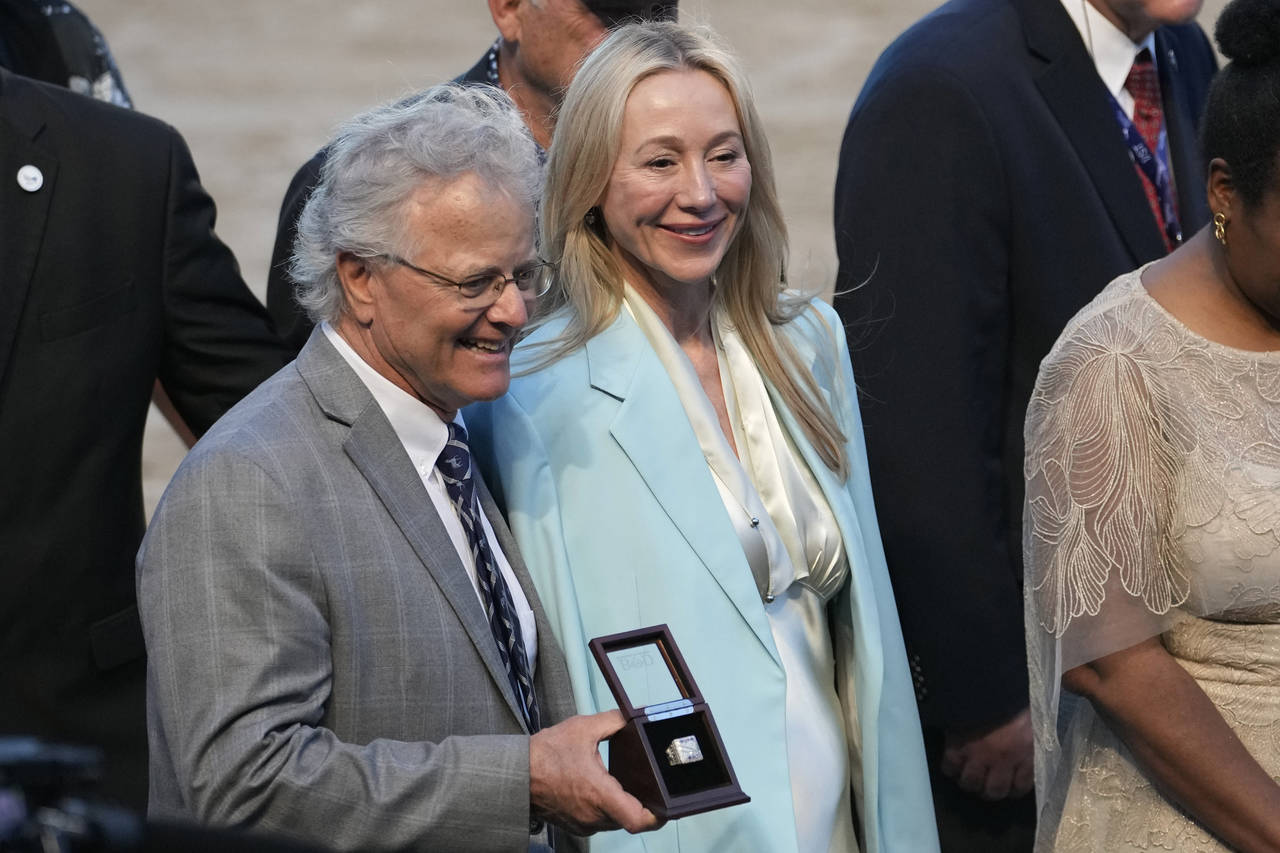 Belinda Stronach, CEO and president of 1/ST, right, stands in the winner's circle with Bill Mott, t...