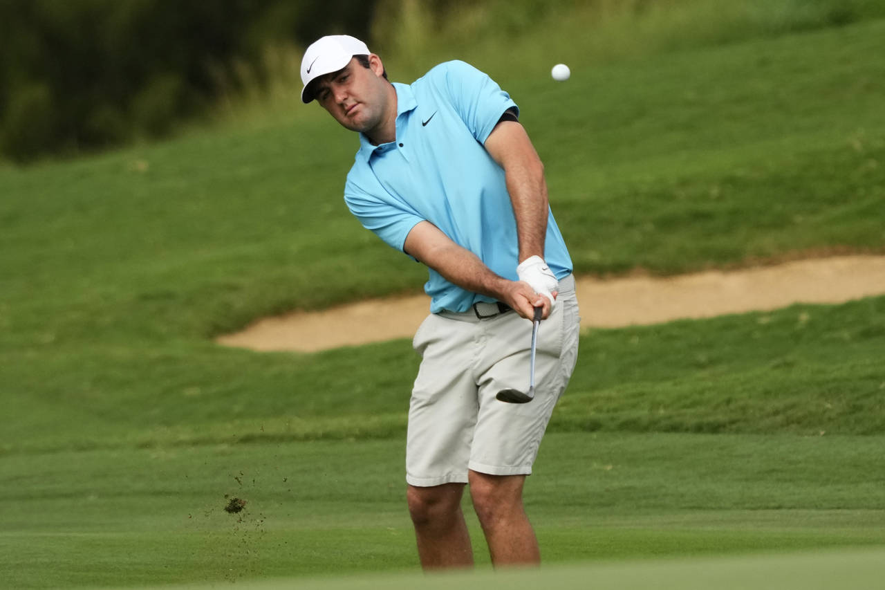 Scottie Scheffler plays a shot from the fringe along on the ninth hole during the Tournament of Cha...