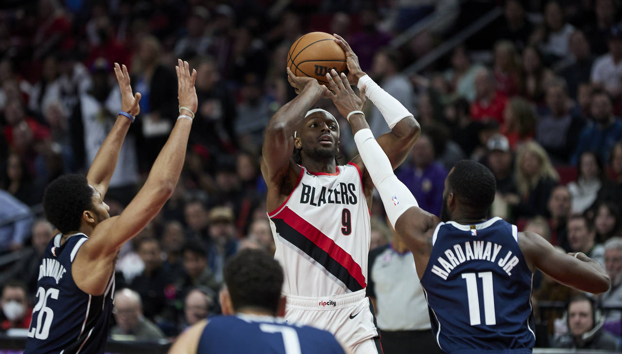 Portland Trail Blazers forward Jerami Grant shoots as Dallas Mavericks forward Tim Hardaway Jr., ri...