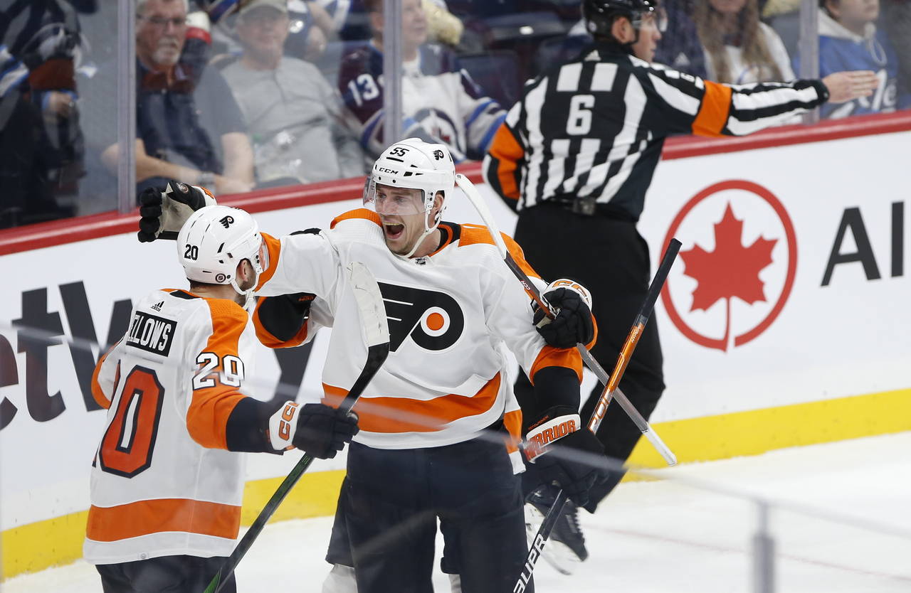 Philadelphia Flyers' Kieffer Bellows (20) and Rasmus Ristolainen (55) celebrate Bellows' goal again...
