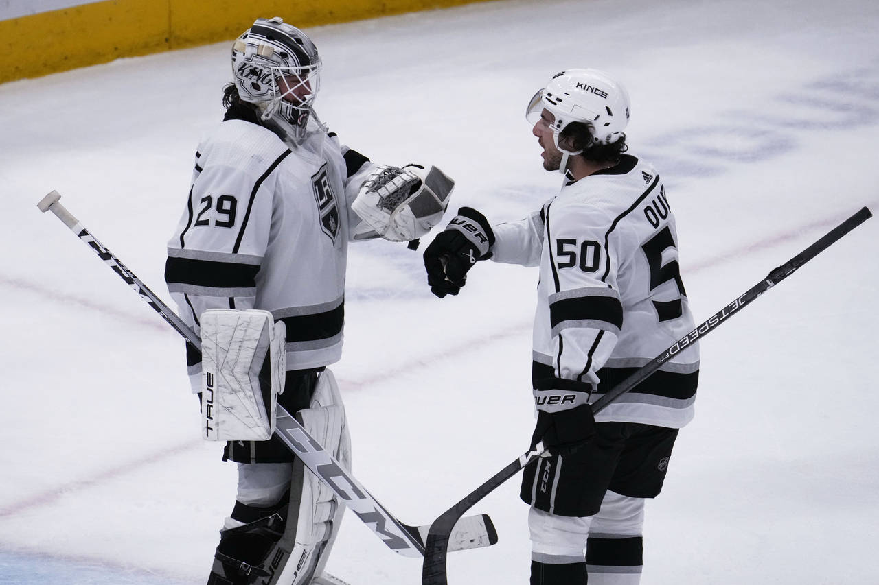 Los Angeles Kings goaltender Pheonix Copley, left, celebrates with defenseman Sean Durzi after the ...