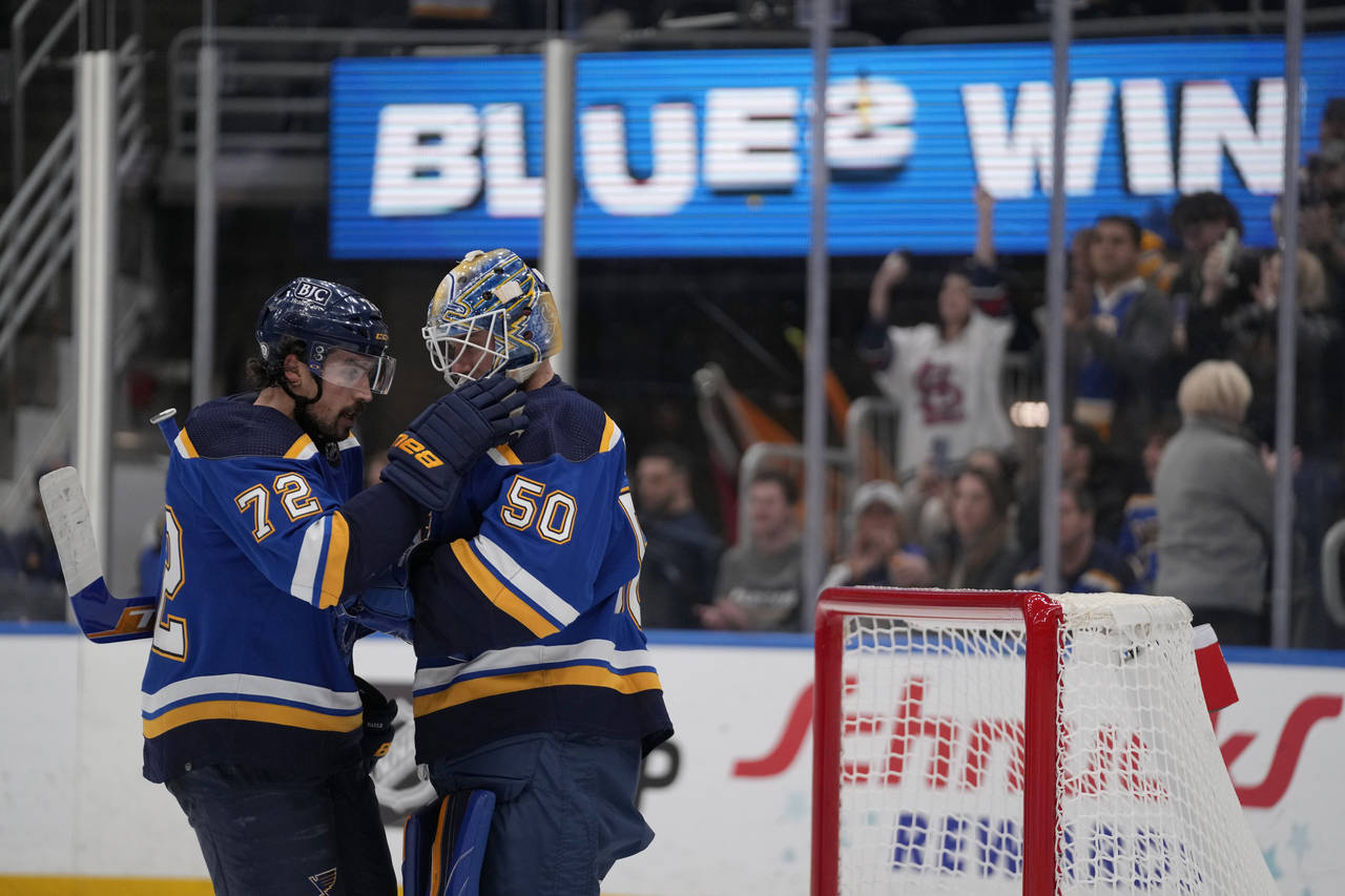 St. Louis Blues goaltender Jordan Binnington (50) and teammate Justin Faulk (72) celebrate a victor...