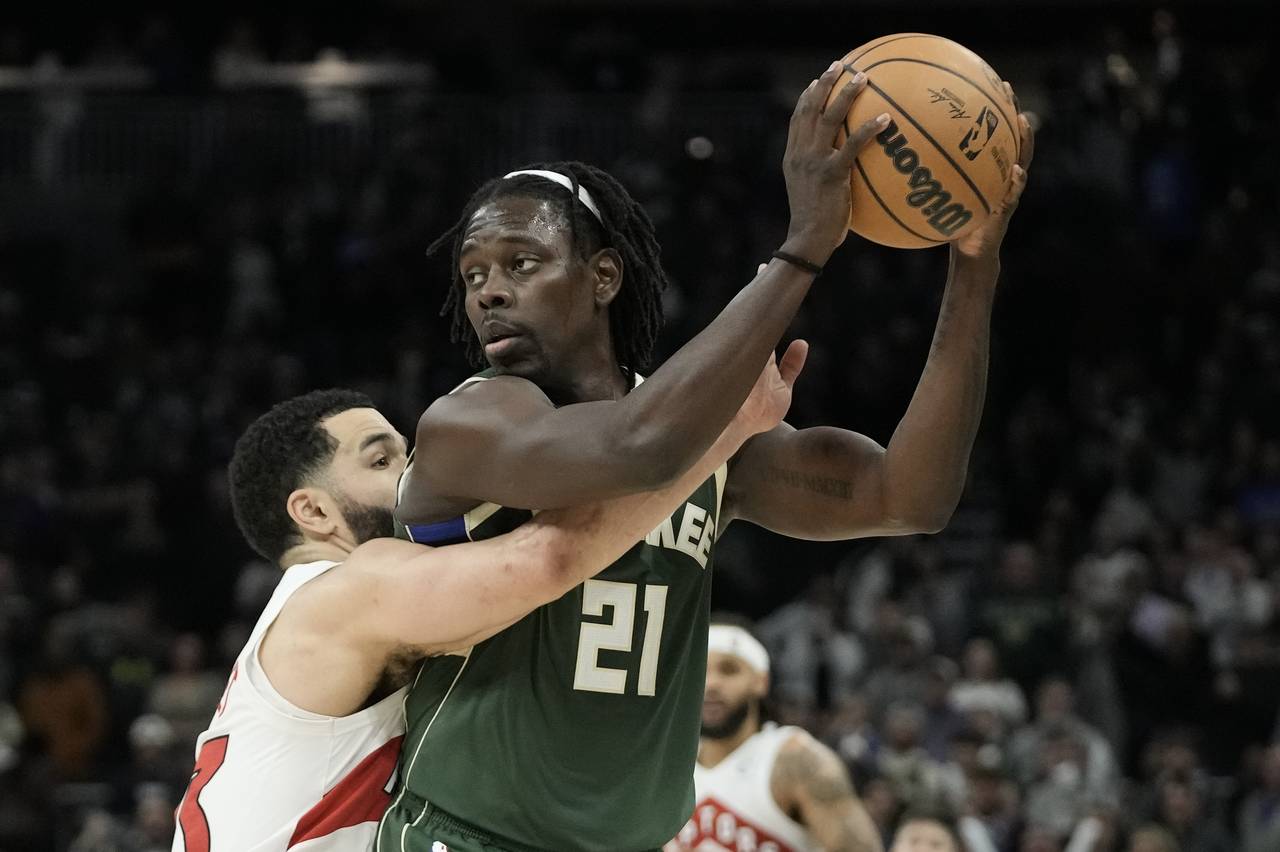 Milwaukee Bucks' Jrue Holiday is fouled by Toronto Raptors' Fred VanVleet during the second half of...