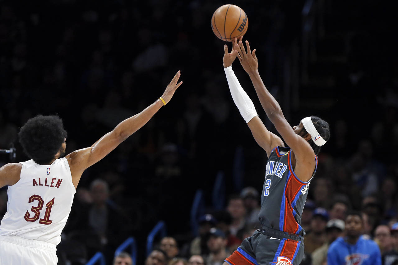 Oklahoma City Thunder guard Shai Gilgeous-Alexander shoots over Cleveland Cavaliers center Jarrett ...
